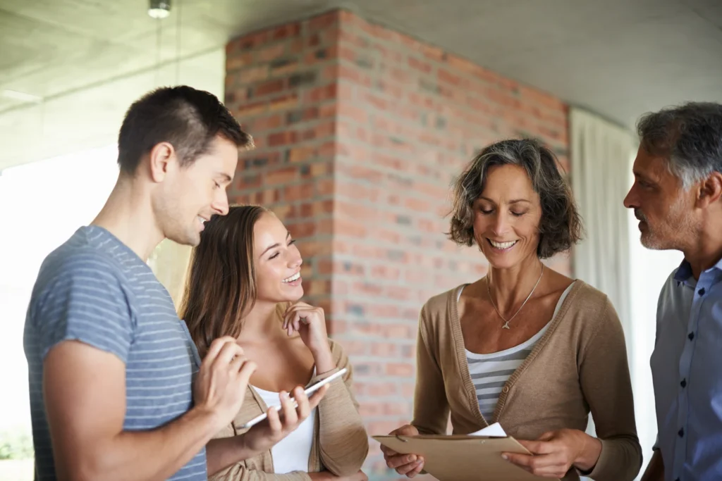 Family standing in front of an exposed brick wall discussing their values.