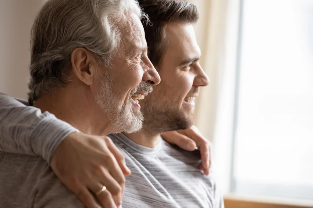 Father and son looking out a window together.