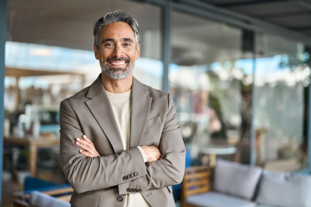 Smiling business owner standing in an office.