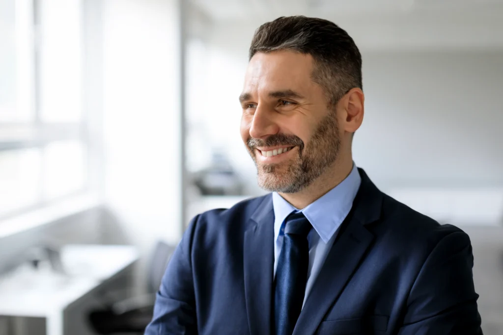 Smiling business owner in a suit and tie.