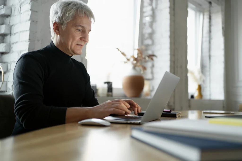 New retiree calculating his required minimum distributions on a laptop.
